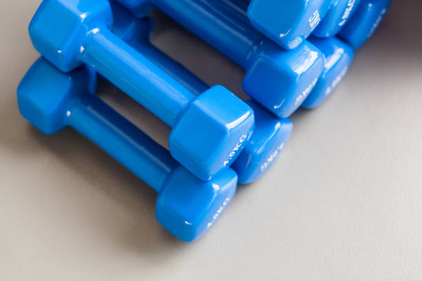 istock Many blue dumbbells folded on the gray floor 900710924