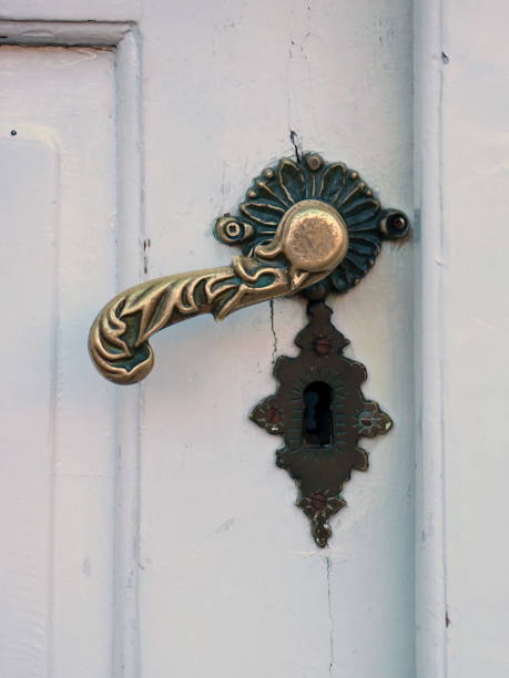 istock Old door handle on the white door 900719440