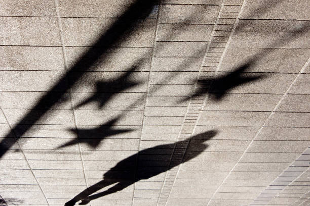 istock Shadow silhouette of people on city sidewalk 900723118