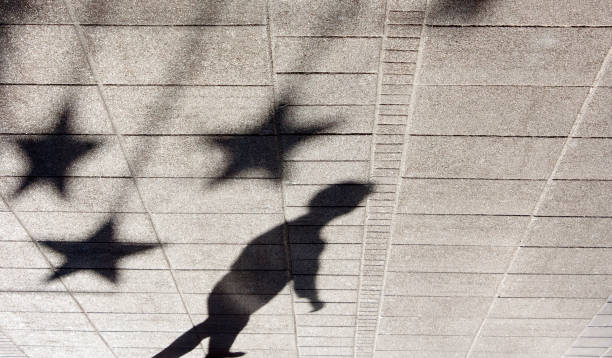 Shadow silhouette of a boy on city sidewalk