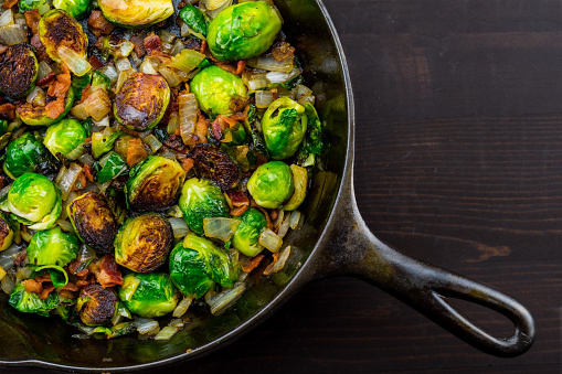 Diagonal Cast Iron Skillet with Brussels Sprouts over dark table top