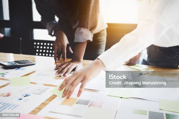 Business Women And Partners Are Analyzing The Companys Marketing Plan With Calculator On Wood Desk In The Workplace Stock Photo - Download Image Now