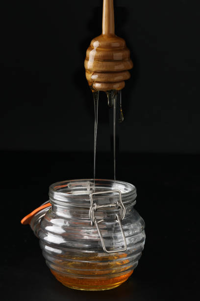 istock Honey dripping from a wooden honey dipper 900737530