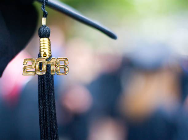 Class of 2018 Graduation Ceremony Tassel Black A black 2018 Tassel on a mortarboard hat representing the class of 2018 at a graduation ceremony 2018 stock pictures, royalty-free photos & images