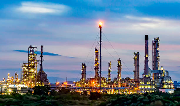 istock Oil refinery at twilight background. 900746490