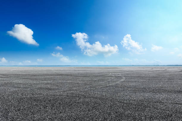 istock asphalt road and blue sky with white clouds by the lake 900749352