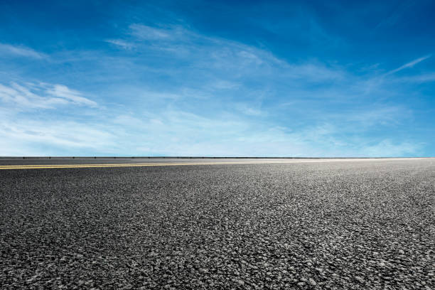istock asphalt road and blue sky and white clouds scene 900749434