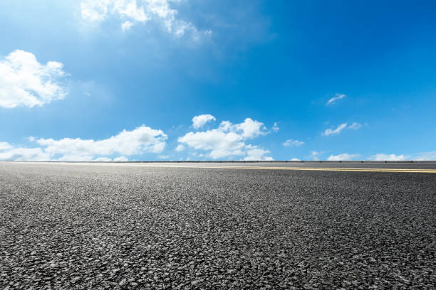 istock asphalt road and blue sky and white clouds scene 900749480