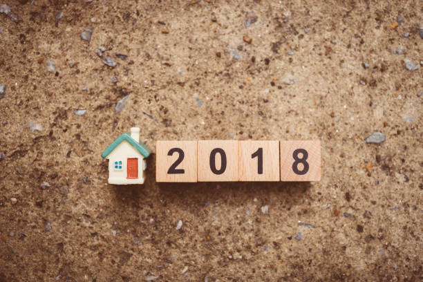 istock Mini house and year 2018 wooden block 900754254