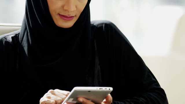 Portrait Arabic businesswoman using wireless tablet city office