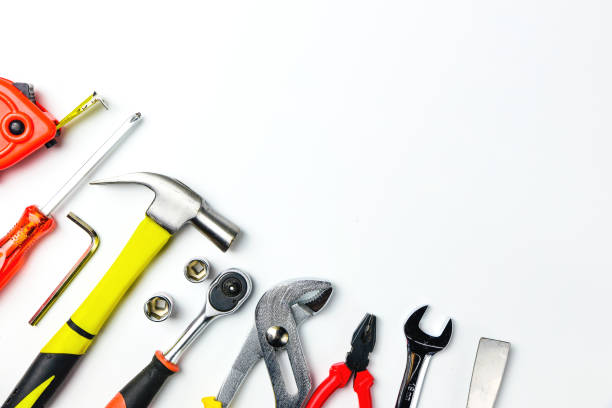 istock Top view of Working tools,wrench,socket wrench,hammer,screwdriver,plier,electric drill,tape measure,machinist square and safety glasses on white background.flat lay design for construction concept. 900763378