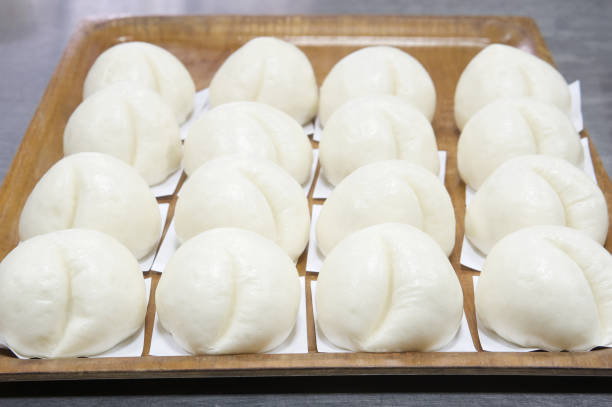istock Steamed bun put in a row on wooden tray 900767734