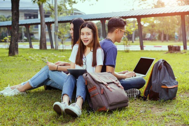 istock Students young asian together working study smiling with tablet,laptop computer at university high school campus,college in summer holiday relaxation 900771652