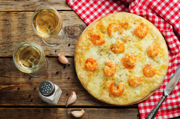 Shrimp garlic cheesy pizza Shrimp garlic cheesy pizza on a wood background. toning. selective focus fish pie stock pictures, royalty-free photos & images