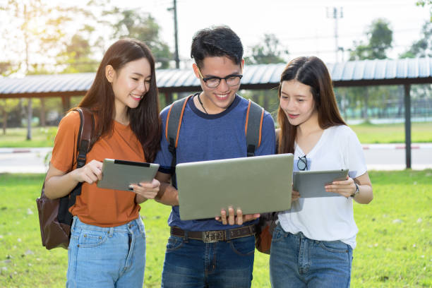 istock Students university asian together study smiling with tablet,laptop computer at university high school campus,college in summer holiday relaxation 900774404
