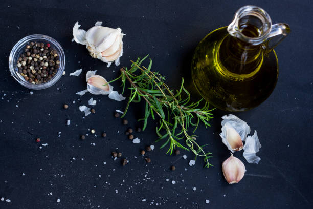 istock Fresh Herbs, Garlic, Pepper and Olive Oil  on Black Background 900775974