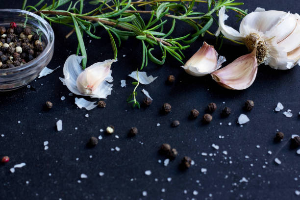 istock Fresh Herbs, Garlic, Pepper and Olive Oil  on Black Background 900775978