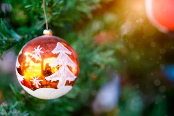 istock Orange Christmas ball hanging on tree with sunlight shiny 900784606