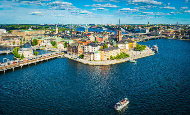 Stockholm aerial panorama over Gamla Stan city waterfront landmarks Sweden Panoramic aerial view over the blue summer skies above the iconic waterfront of Gamla Stan and Sodermalm in the heart of Stockholm, Sweden's vibrant capital city. stockholm stock pictures, royalty-free photos & images