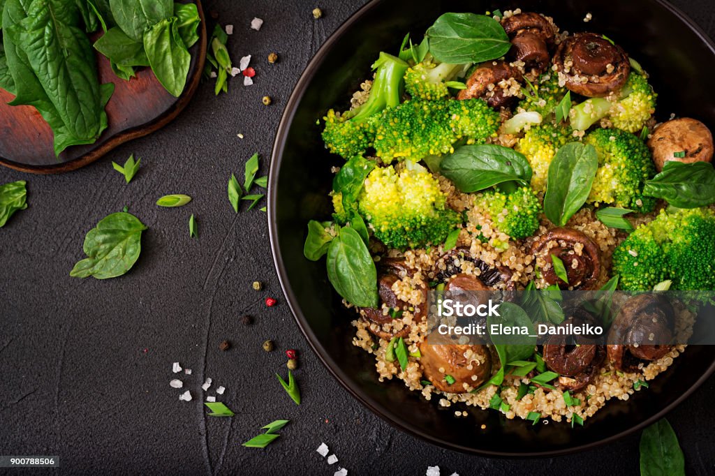 Dietary menu. Healthy vegan salad of vegetables - broccoli, mushrooms, spinach and quinoa in a bowl. Flat lay. Top view Vegan Food Stock Photo