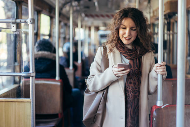 istock Young woman using smartphone on the tram 900792108
