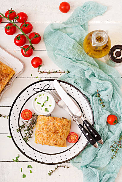 istock Appetizing strudel with minced beef, onions and herbs. Flat lay. Top view 900792756