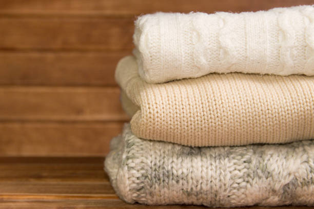istock Stack of cozy knitted warm sweater ,wooden background 900793076