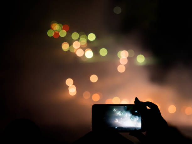 istock taking picture at night in new years eve at torchlight procession 900793154