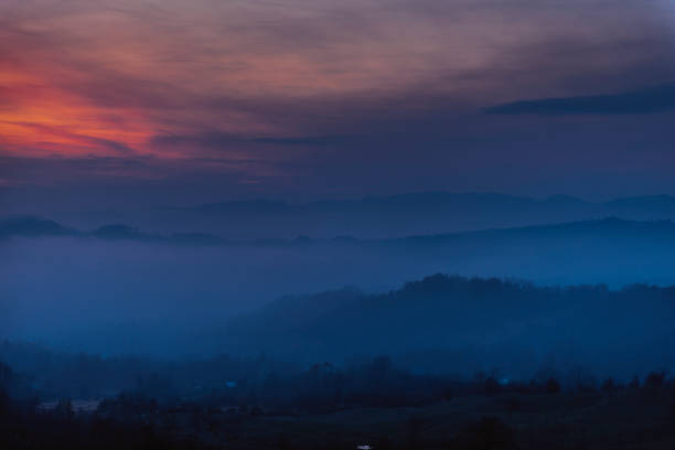 istock Foggy Landscape at Dusk 900799796