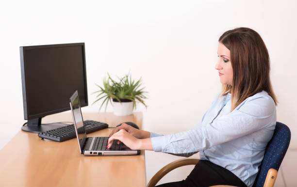 istock Cute woman working on the notebook in the office 900799910