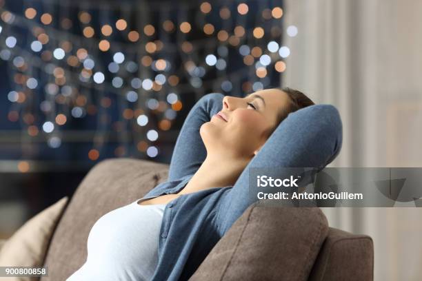Woman Resting On A Couch In The Night At Home Stock Photo - Download Image Now - Vacations, Emotional Stress, Night