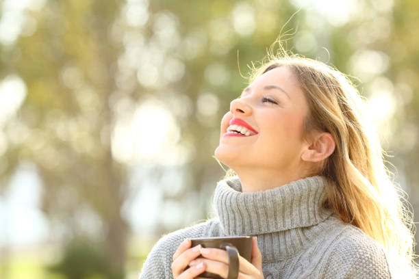 istock Happy lady breathing fresh air in winter 900801058