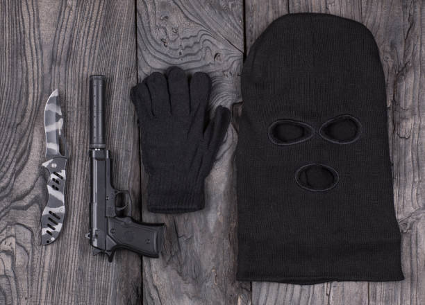 istock mask of the killer, pistol 900803918