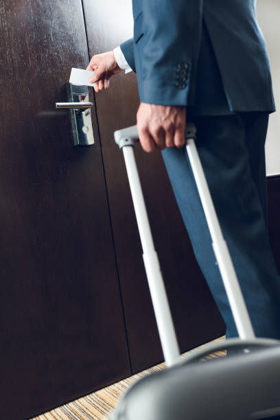 istock businessman with suitcase opening door 900804460