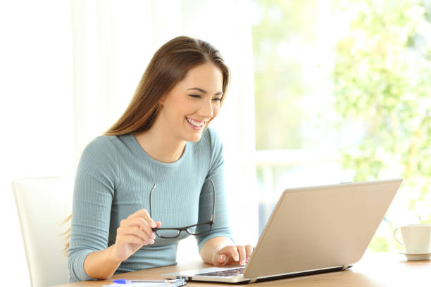 istock Woman browsing on line content in a laptop 900807156
