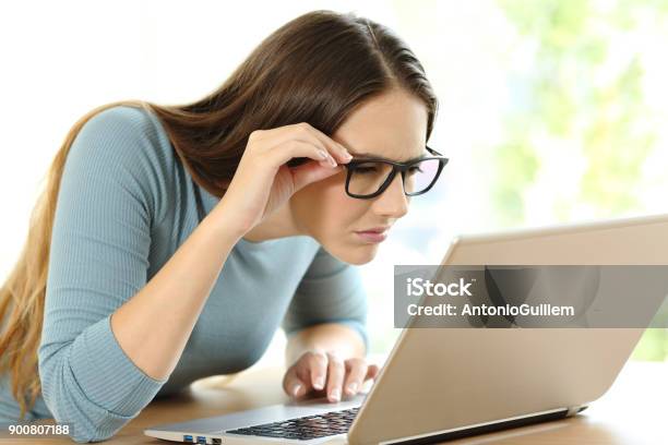Woman With Eyesight Problems To Read On Line Content Stock Photo - Download Image Now