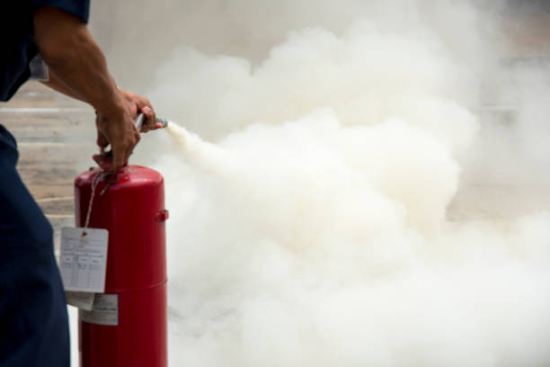 istock A man practises how to use a fire-extinguisher 900807758
