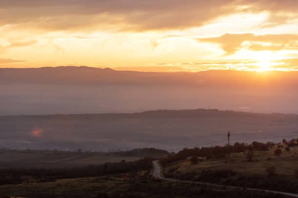 istock lonely road passing by mountains during a cloudy sunrise 900809048