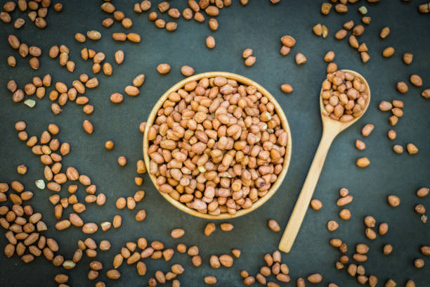 istock Peanuts in wooden bowl 900809170