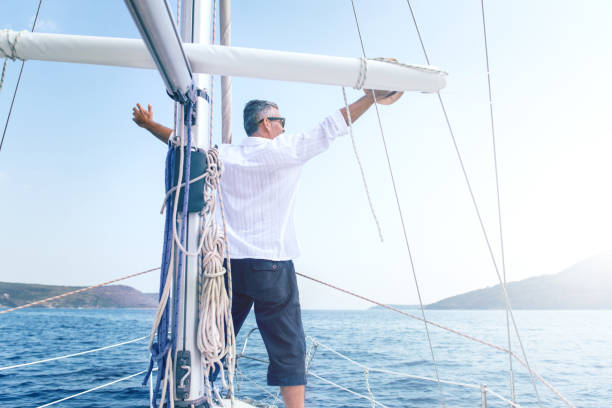 istock Man enjoying sailing with sailboat 900811408