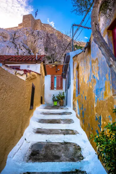 Photo of Street of Anafiotika in the old town of Athens, Greece. Anafiotika is district built by workers from the island Anafi. Popular tourist attraction.