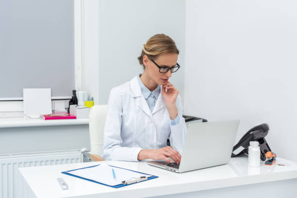 istock female doctor using laptop 900812422