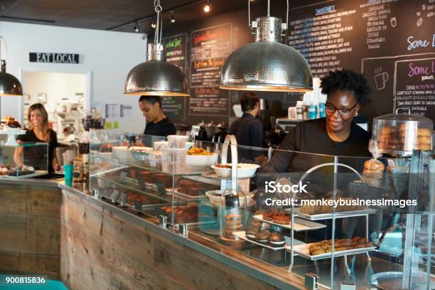 Staff Working Behind Counter In Busy Coffee Shop Stock Photo - Download Image Now - Coffee Shop, Small Business, Employee