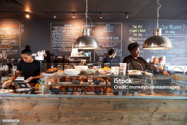 Staff Working Behind Counter In Busy Coffee Shop Stock Photo - Download Image Now - Coffee Shop, Cafe, Small Business