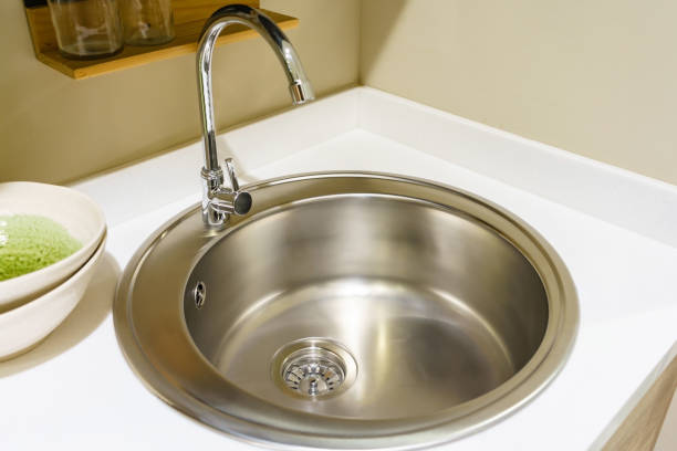 istock Stainless steel kitchen faucet and sink with light countertop 900816096