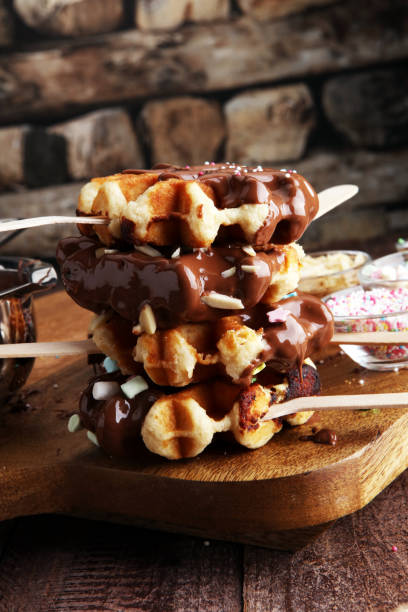 istock Belgium waffles with chocolate sauce. popsicles with chocolate and wafer 900816636