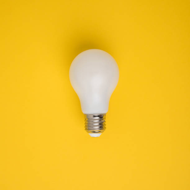 istock close up view of white light bulb isolated on yellow 900817018