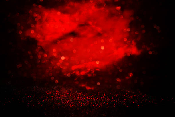 istock black and red glitter lights background. defocused. 900817680