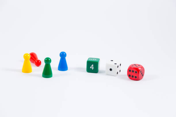 istock three colored dice and four playing stones isolated on white background 900820774