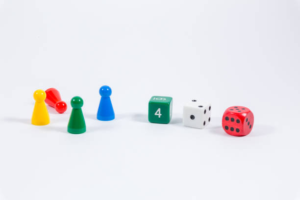 istock three colored dice and four playing stones isolated on white background 900820912